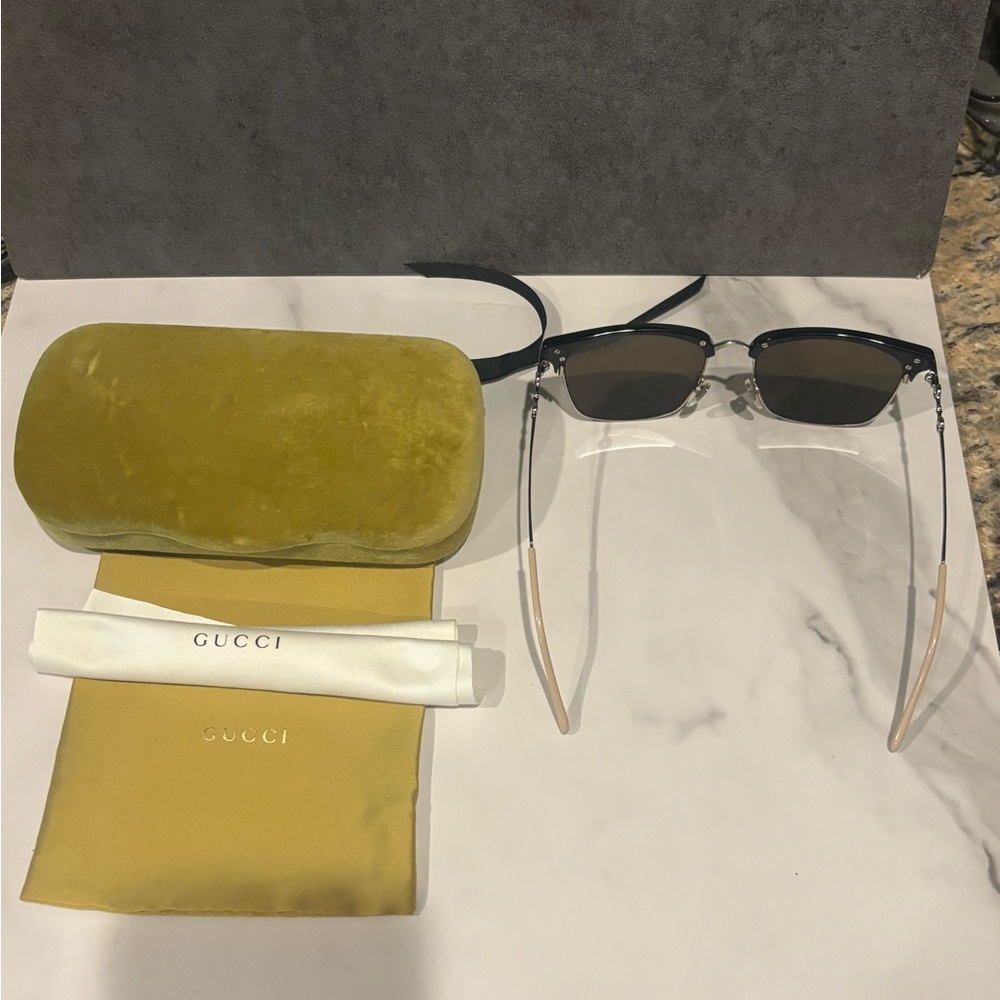 Gucci sunglasses with green velvet case.